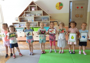Dziewczynki prezentują ilustracje owoców